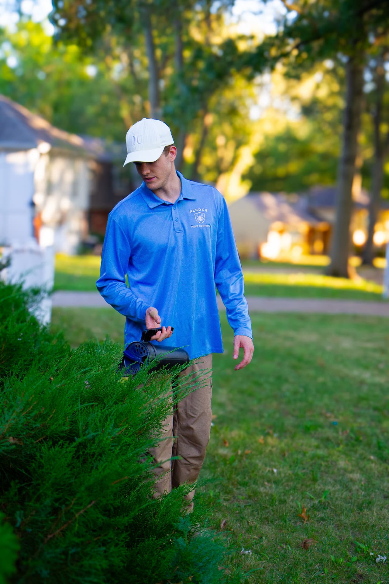 mosquito control tech dusting a yard