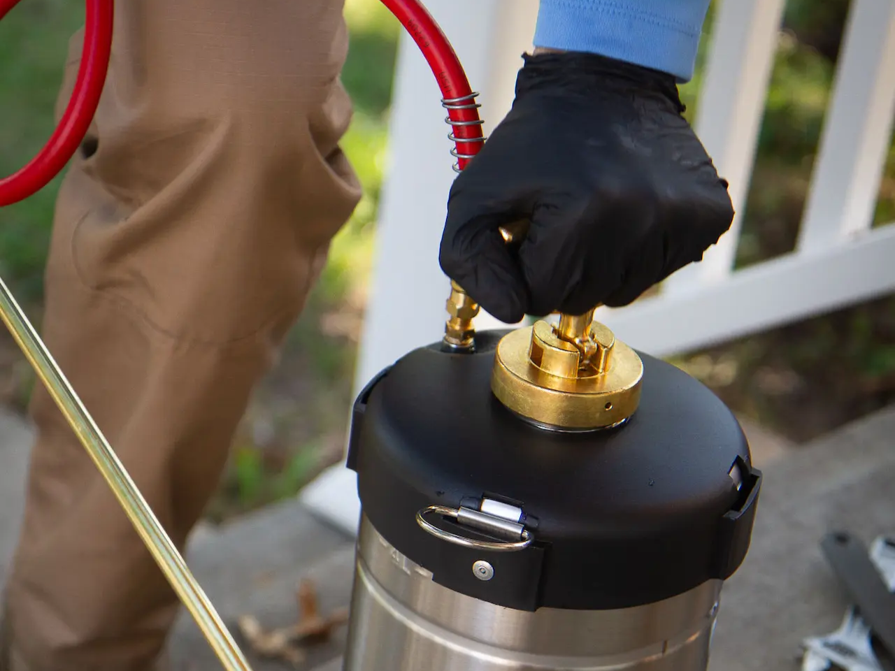 a pest control technician pumping solution in Platte City